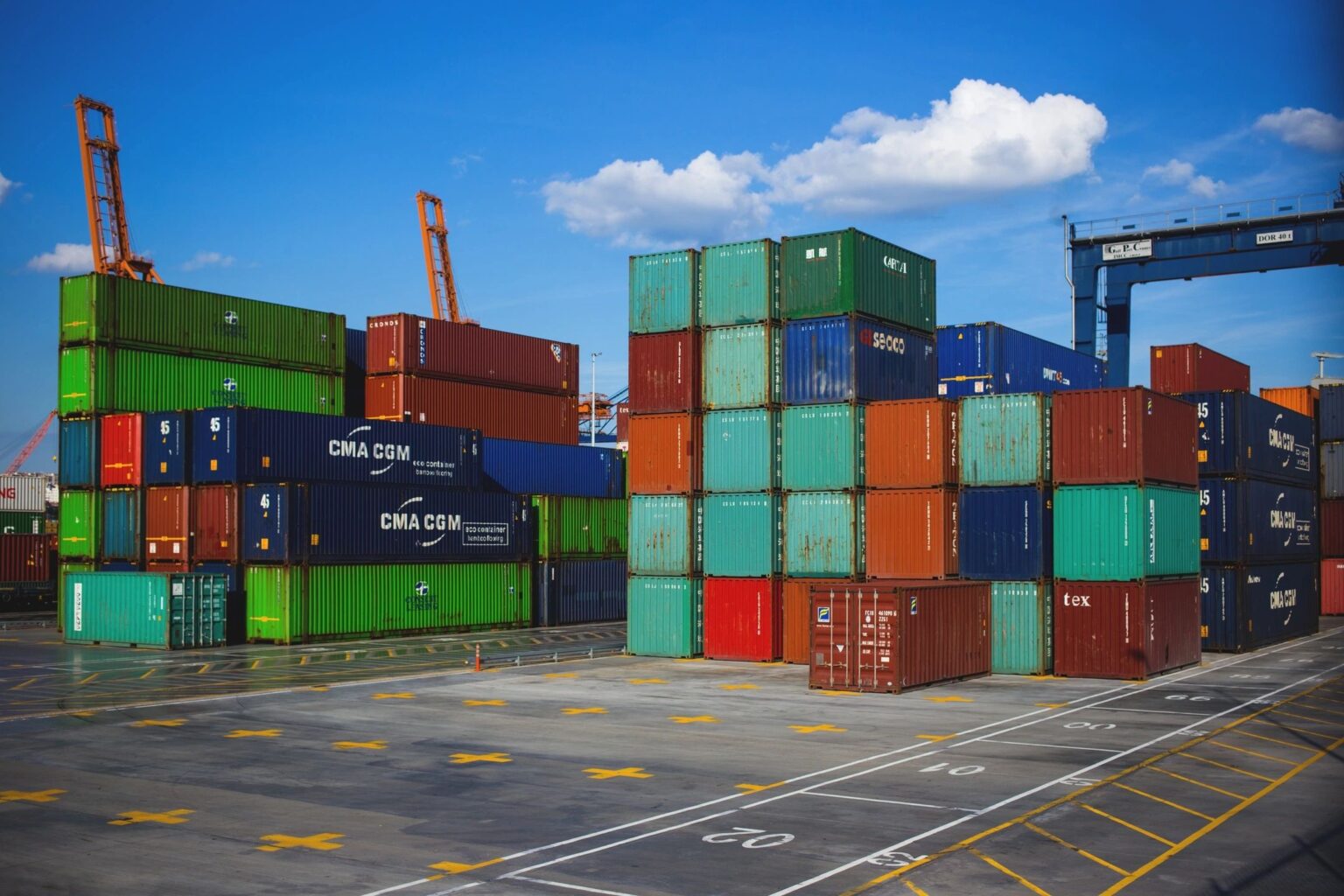 Stacked colorful shipping containers at port yard